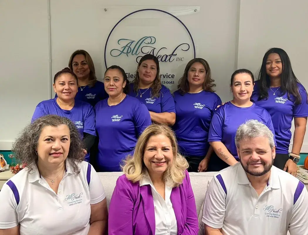 Full team of All Neat Cleaning Services smiling and posing together in uniform